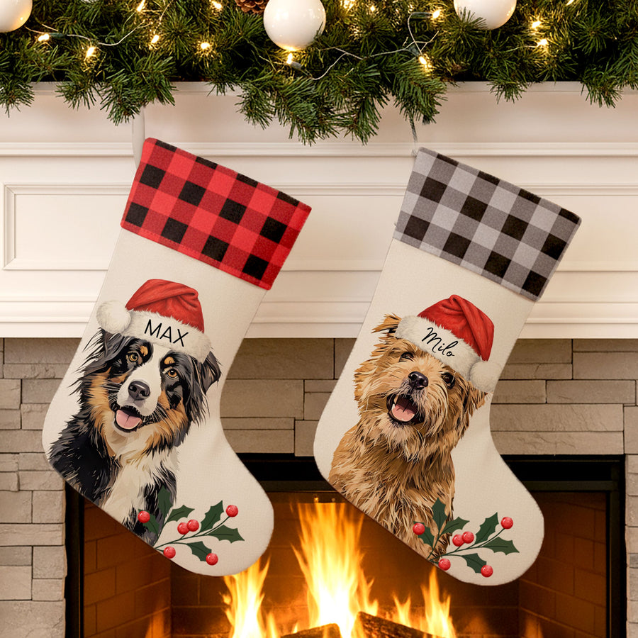 Two Christmas stockings with dog illustrations and Santa hats in front of a fireplace.